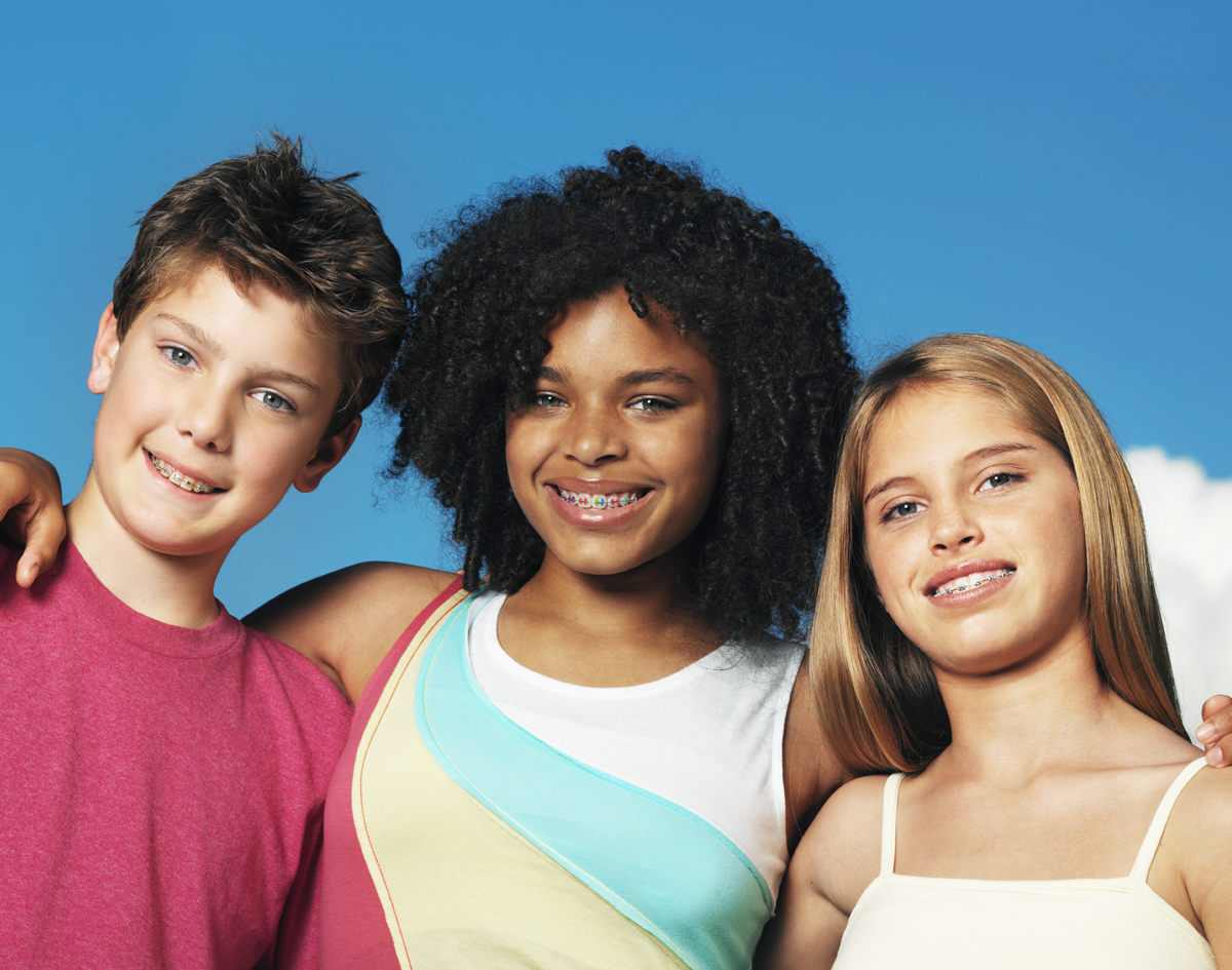 Michael-Riordan-Orthodontics-three-kids-wearing-braces-smiling